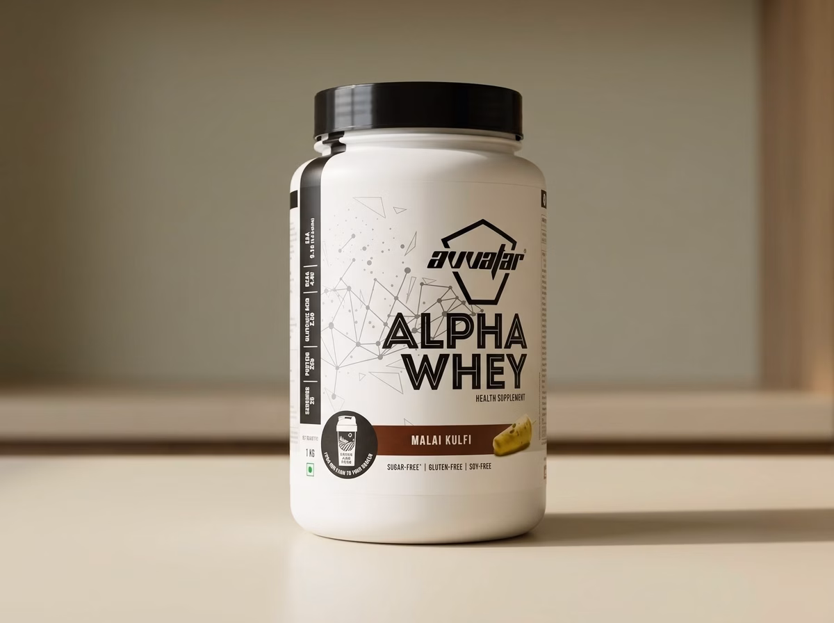 Avvatar Alpha Whey Protein 1 kg Malai Kulfi tub on a kitchen counter
