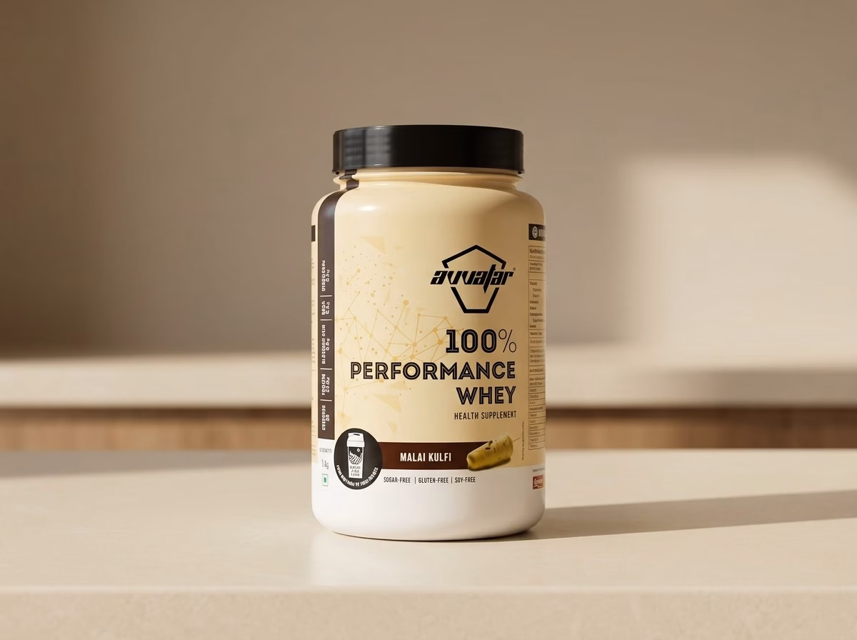 Avvatar 100% Performance Whey, Malai Kulfi, 1 kg tub on a kitchen counter